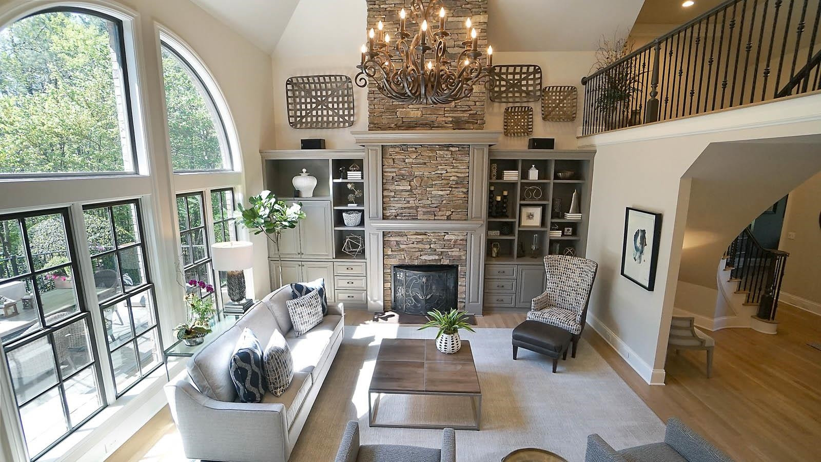 1129 Devlin Court Raleigh, NC 27614 - Photo 6 of 63 Stunning 2 story family room with stone fireplace, a wall of window for natural lighting and newly refinished lighter hardwood floors. Family Room