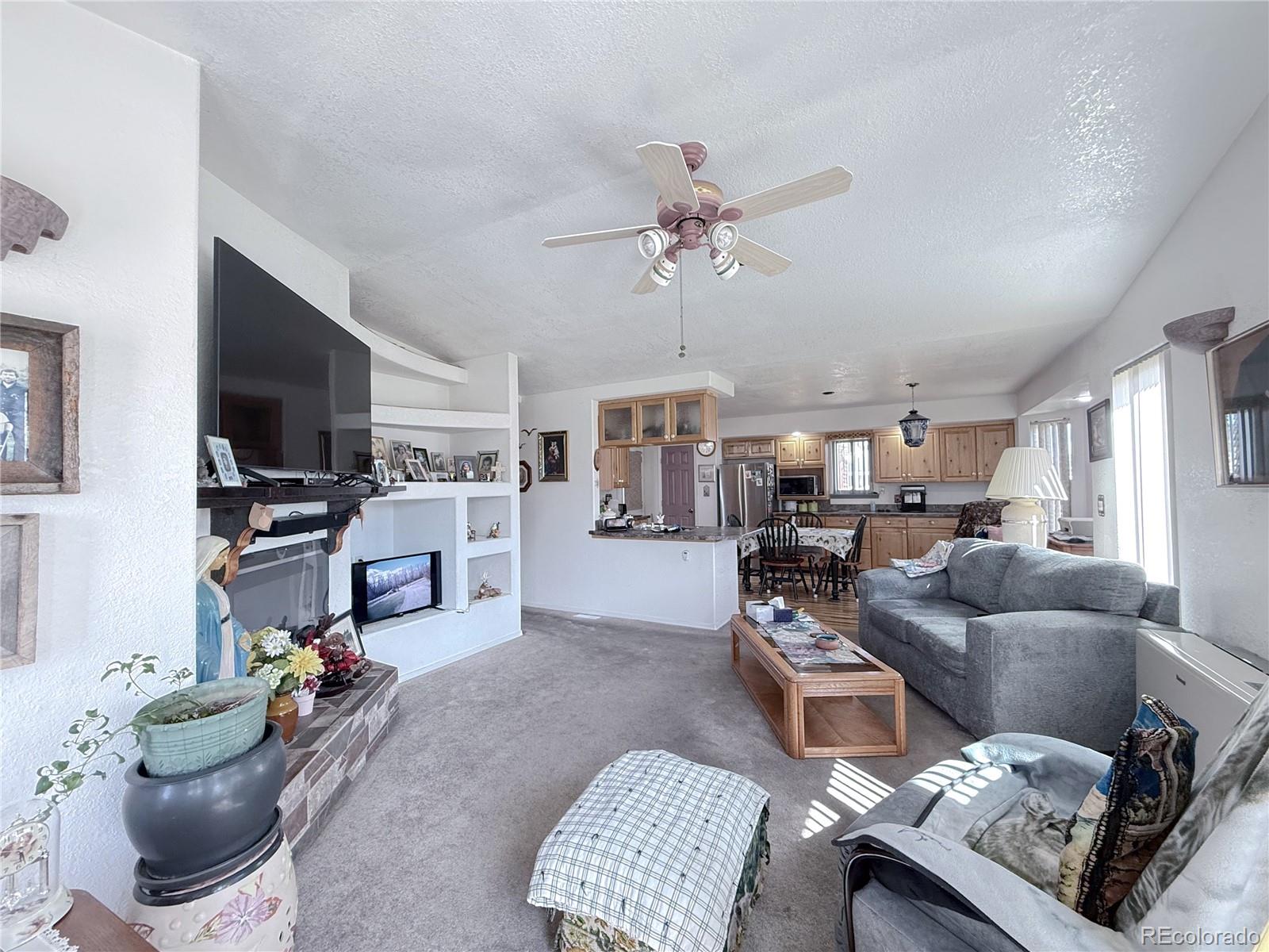20899 County Rd L.7 San Luis, CO 81152 - Photo 11 of 36 a living room with furniture and a flat screen tv
