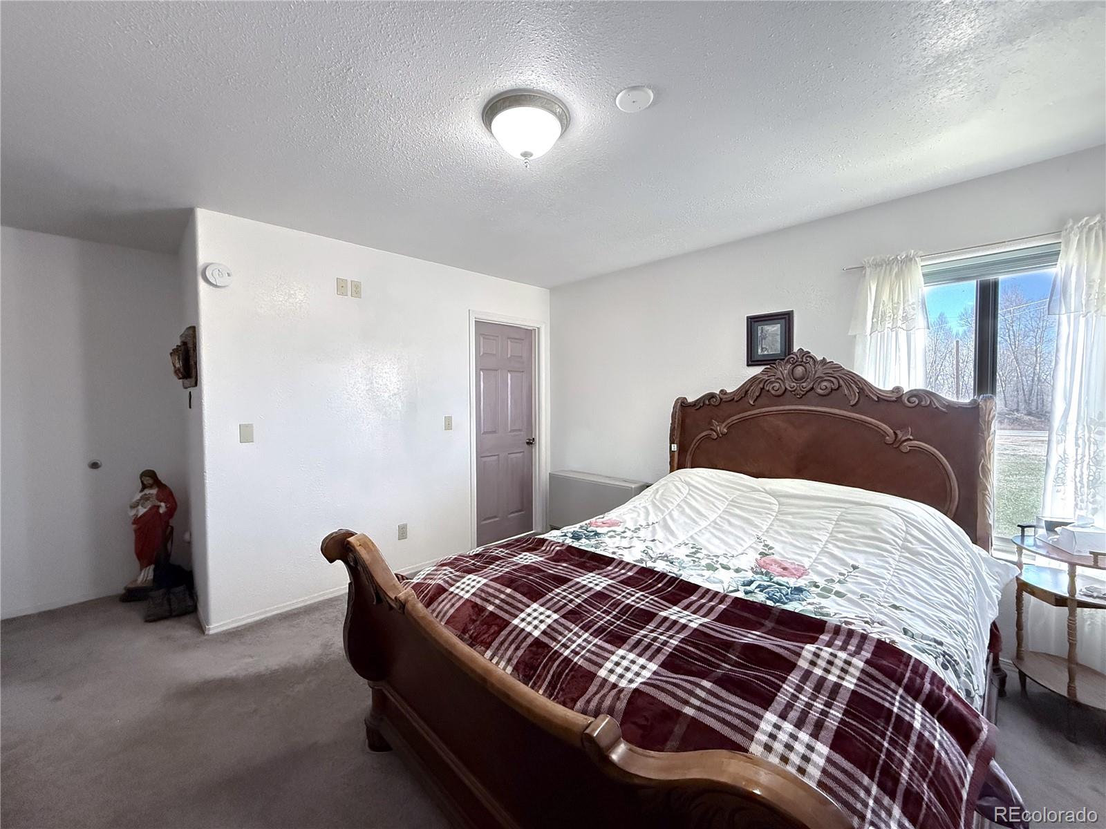 20899 County Rd L.7 San Luis, CO 81152 - Photo 14 of 36 a bedroom with a bed and a window