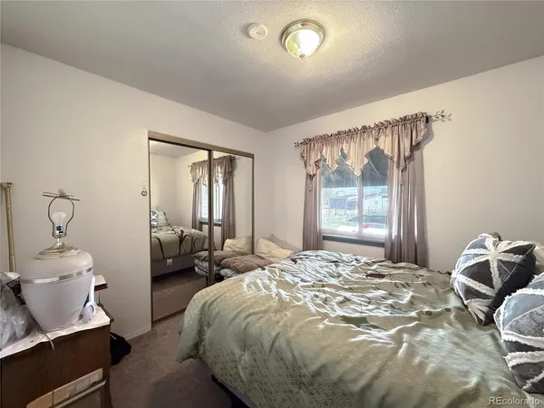 a bedroom with furniture and a window