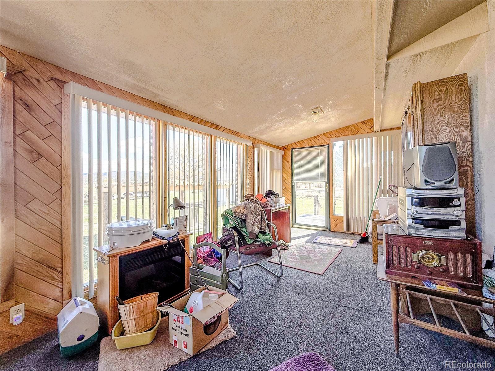 20899 County Rd L.7 San Luis, CO 81152 - Photo 23 of 36 a living room with furniture and a floor to ceiling window