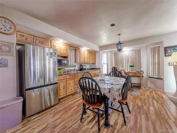 a living room with furniture and a flat screen tv with kitchen view
