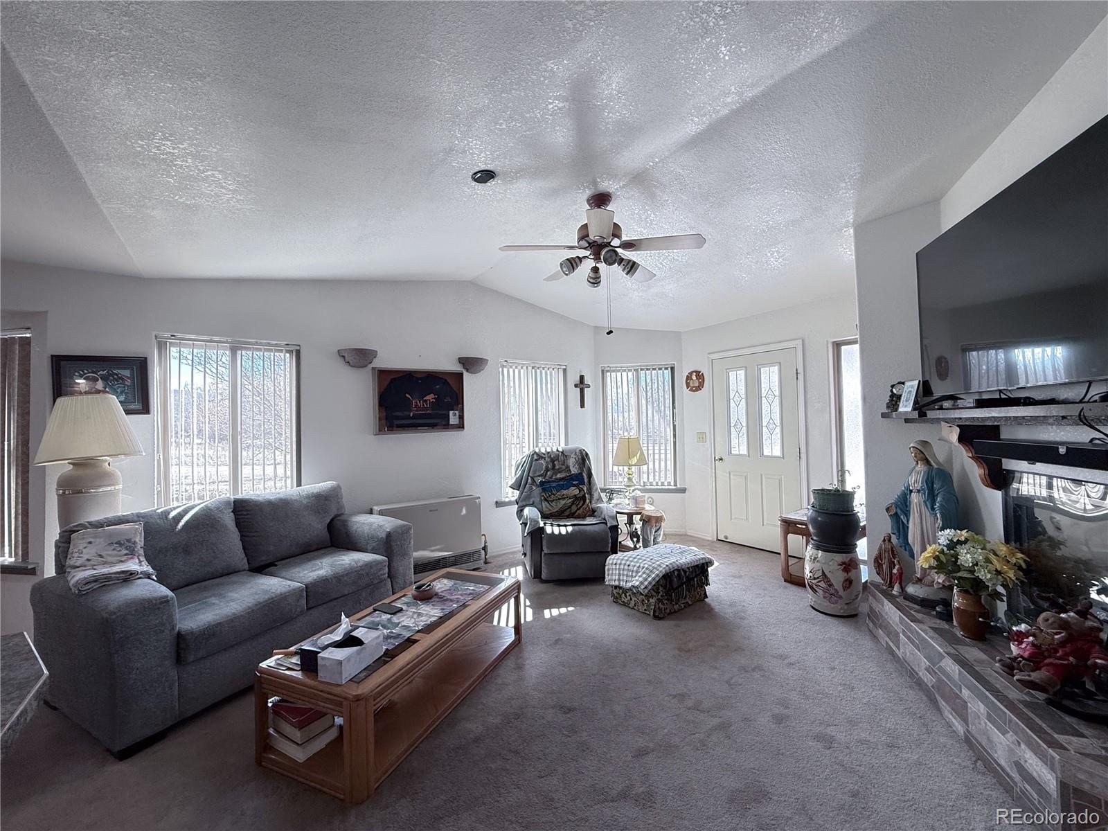 20899 County Rd L.7 San Luis, CO 81152 - Photo 10 of 36 a living room with furniture a window and a flat screen tv