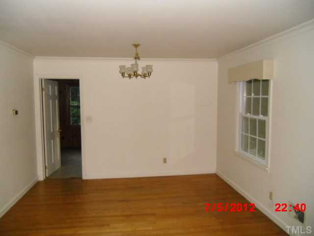 4204 Boxwood Road Raleigh, NC 27612 - Photo 3 of 13 a view of an empty room with window and wooden floor
