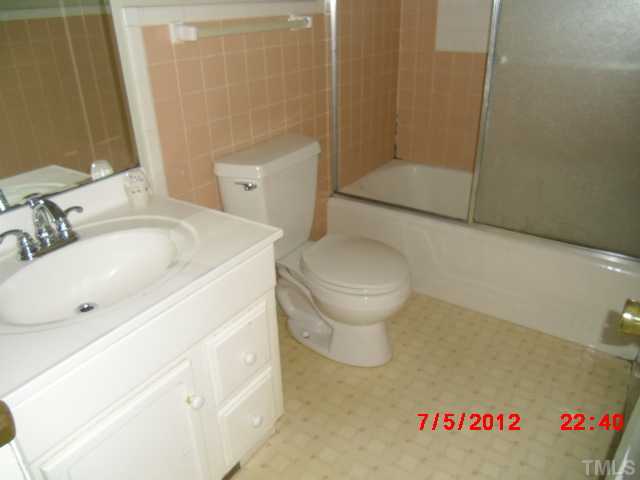 4204 Boxwood Road Raleigh, NC 27612 - Photo 5 of 13 a bathroom with a sink toilet and shower