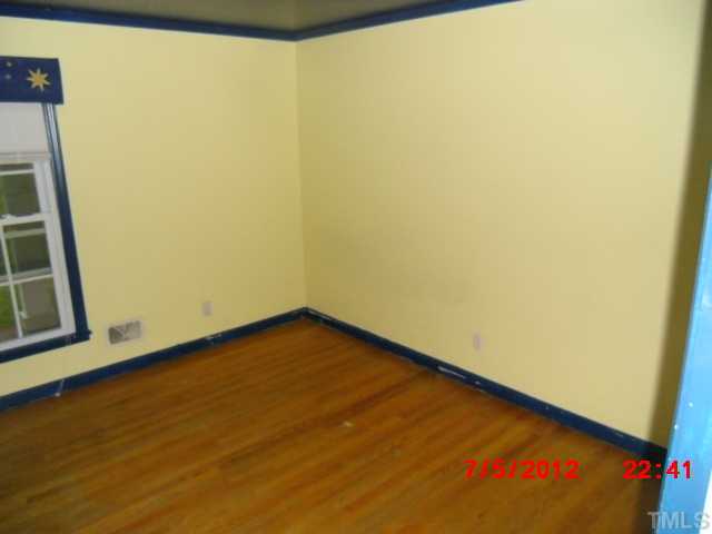 4204 Boxwood Road Raleigh, NC 27612 - Photo 6 of 13 a view of a small space with wooden floor and a window