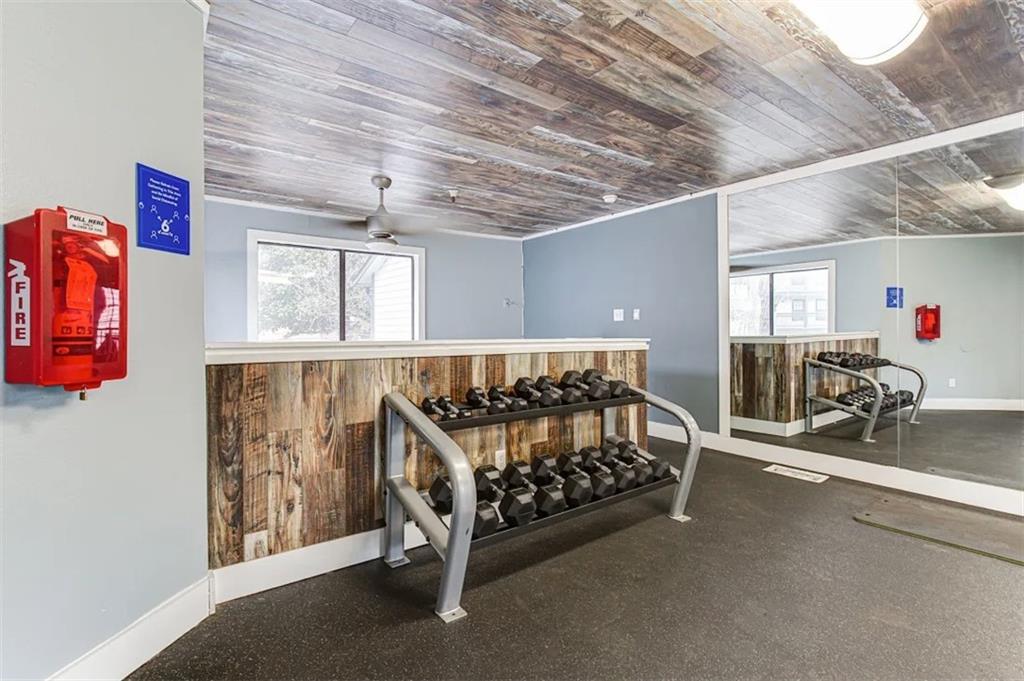 2330 Cobb Parkway Southeast, Unit 322 Smyrna, GA 30080 - Photo 14 of 19 a bedroom with furniture and a window