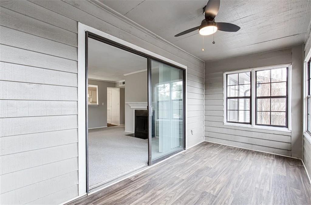 2330 Cobb Parkway Southeast, Unit 322 Smyrna, GA 30080 - Photo 7 of 19 en empty room with wooden floor and windows