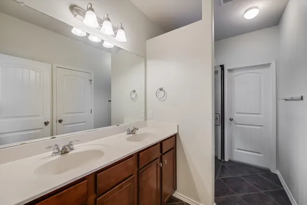 a bathroom with a sink double vanity and a mirror
