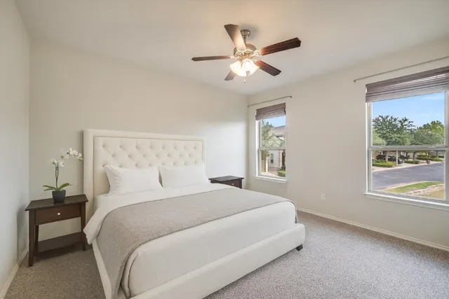 a bedroom with a large bed and a window