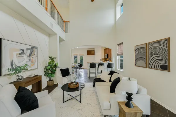 a living room with furniture and a floor to ceiling window