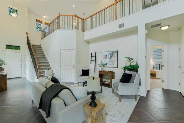a living room with fireplace furniture and a potted plant