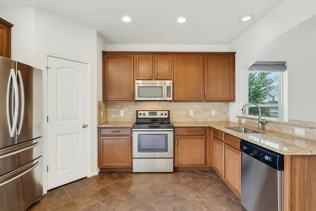 a kitchen with a sink stove and refrigerator