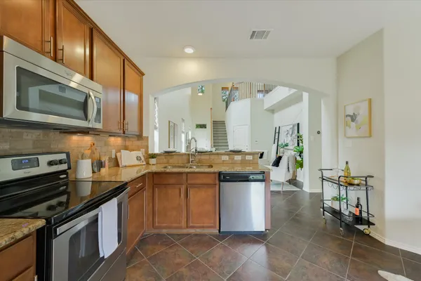 a kitchen with a sink stove and cabinets