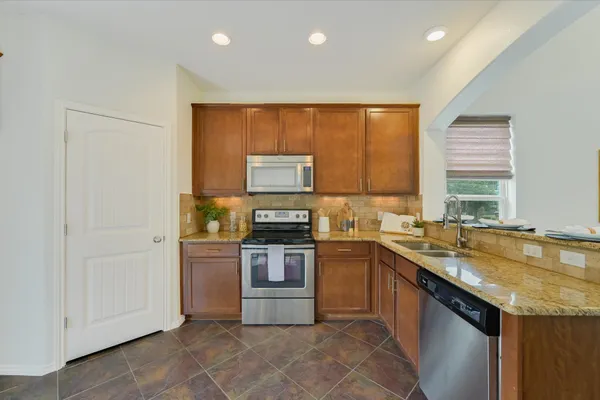 a kitchen with a sink stove and cabinets