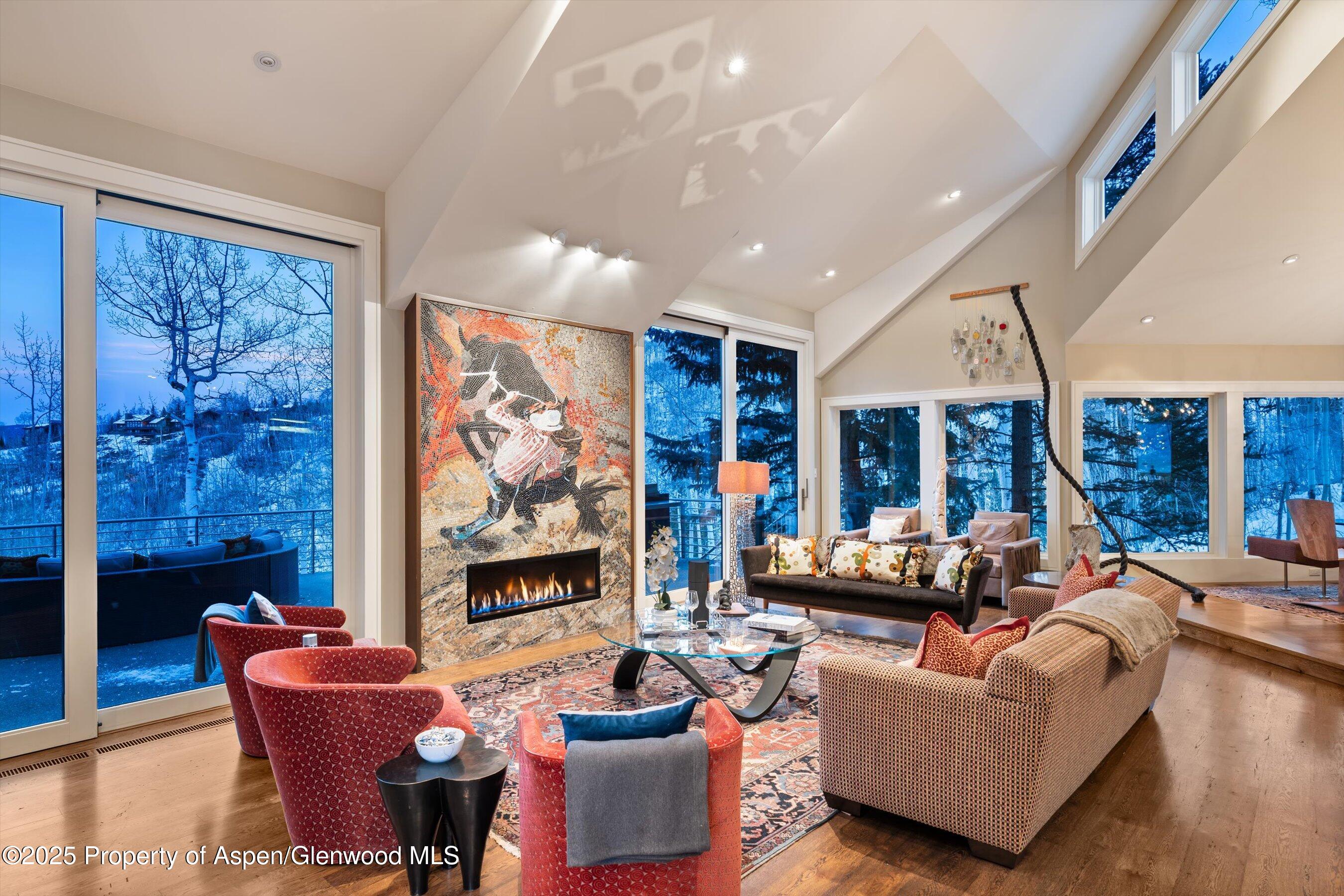 a living room with fireplace furniture and a large window
