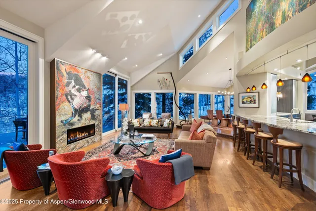 a living room with furniture a rug and a fireplace