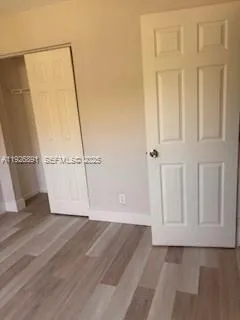 a kitchen with a refrigerator and a stove top oven