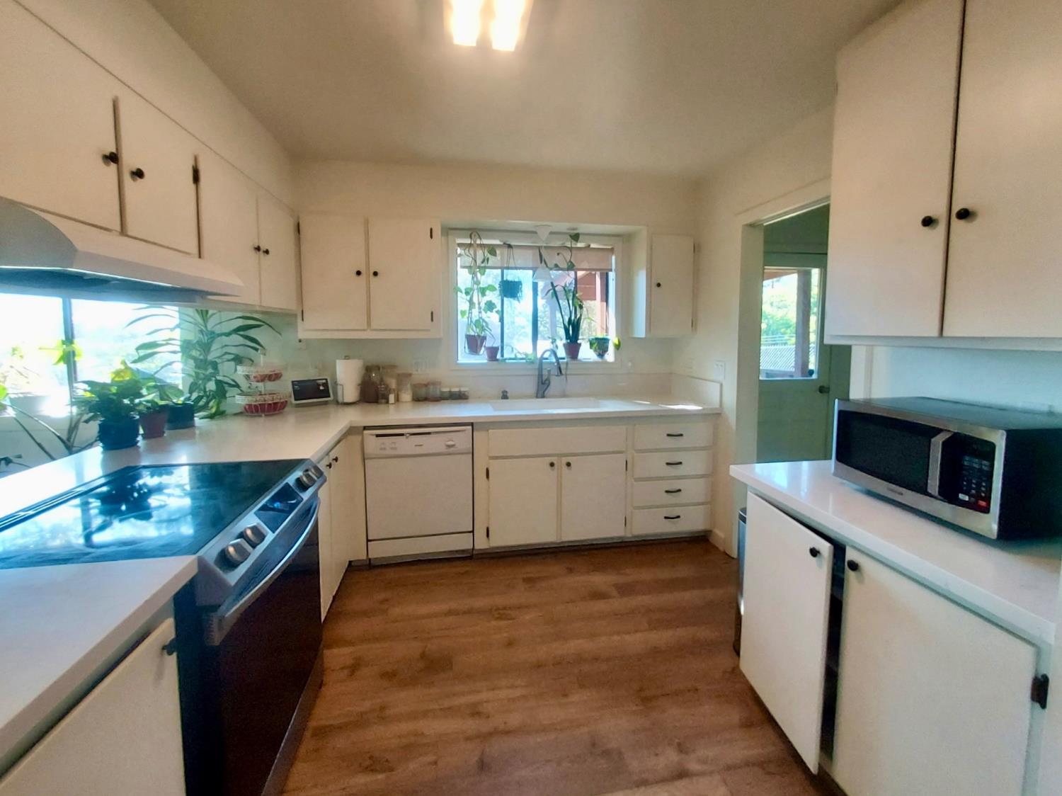 6880 Kahala Road Garden Valley, CA 95633 - Photo 4 of 52 a kitchen with a sink stove and cabinets