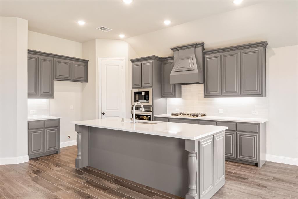 14426 McClint Street Pilot Point, TX 76258 - Photo 12 of 34 a kitchen with stainless steel appliances granite countertop a sink stove and refrigerator
