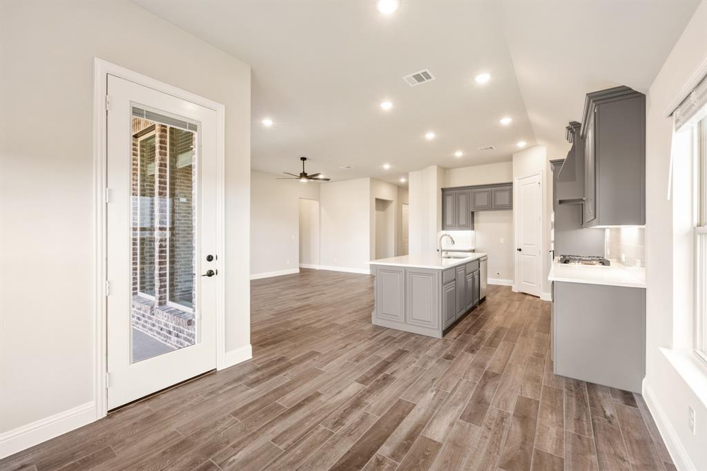 14426 McClint Street Pilot Point, TX 76258 - Photo 14 of 34 a large room with a lot of kitchen island with wooden floor