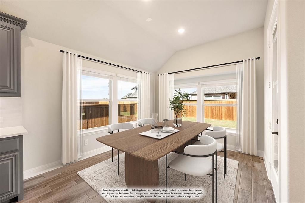 14426 McClint Street Pilot Point, TX 76258 - Photo 17 of 34 a view of a dining room with furniture and wooden floor