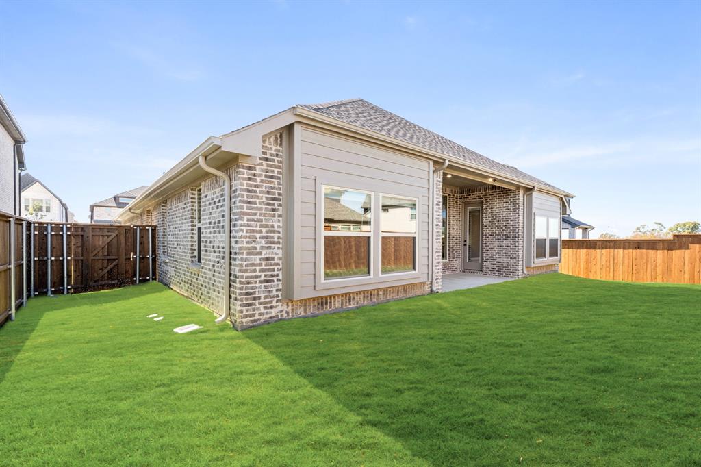 14426 McClint Street Pilot Point, TX 76258 - Photo 32 of 34 a view of a house with backyard and garden
