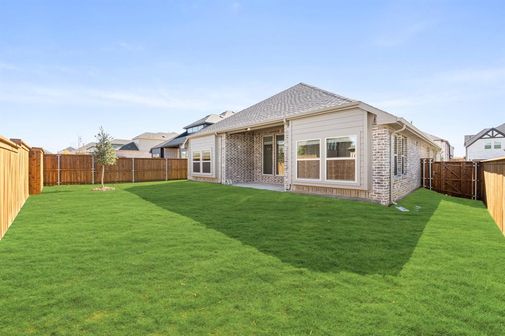 14426 McClint Street Pilot Point, TX 76258 - Photo 33 of 34 a front view of house with yard and green space