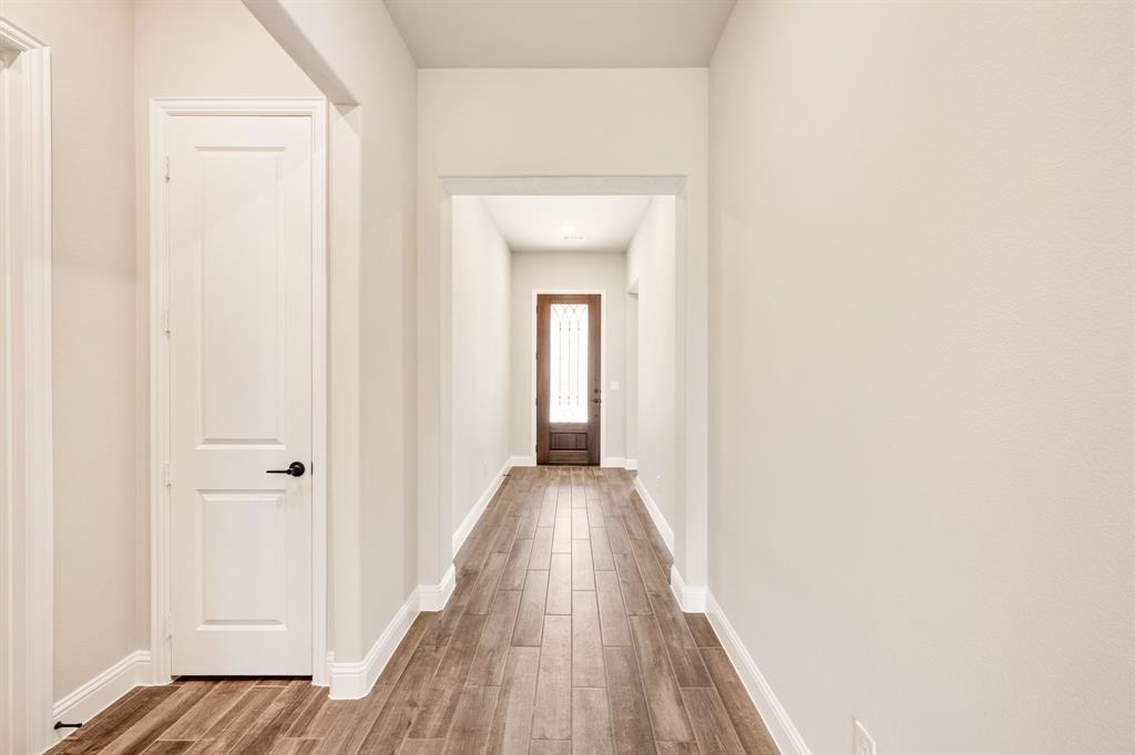 14426 McClint Street Pilot Point, TX 76258 - Photo 5 of 34 a view of a hallway with wooden floor