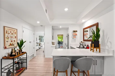 a kitchen with stainless steel appliances granite countertop sink table and chairs