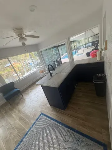 a living room with a glass table next to a large window
