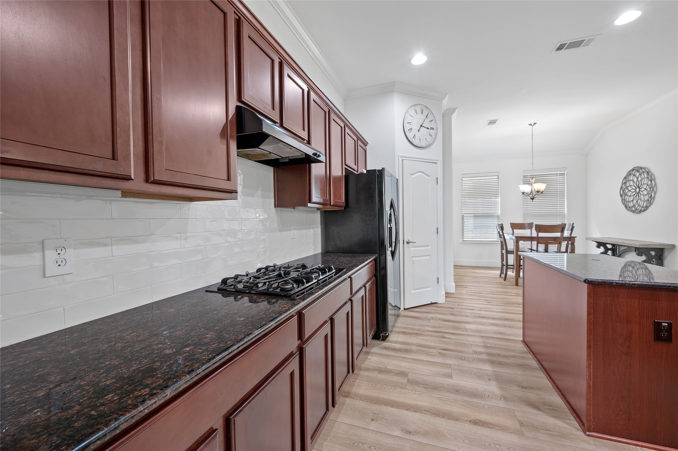 4512 Pyrenees Pass Bee Cave, TX 78738 - Photo 10 of 35 a kitchen with stainless steel appliances granite countertop a stove a sink dishwasher and refrigerator with wooden floor