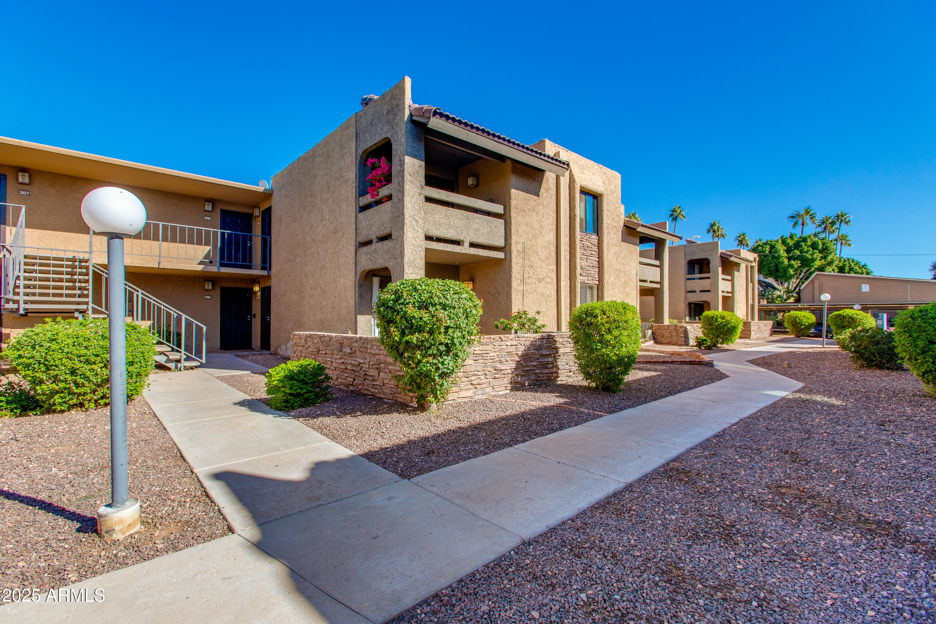 3825 East Camelback Road, Unit 105 Phoenix, AZ 85018 - Photo 14 of 14 a front view of a house with garden
