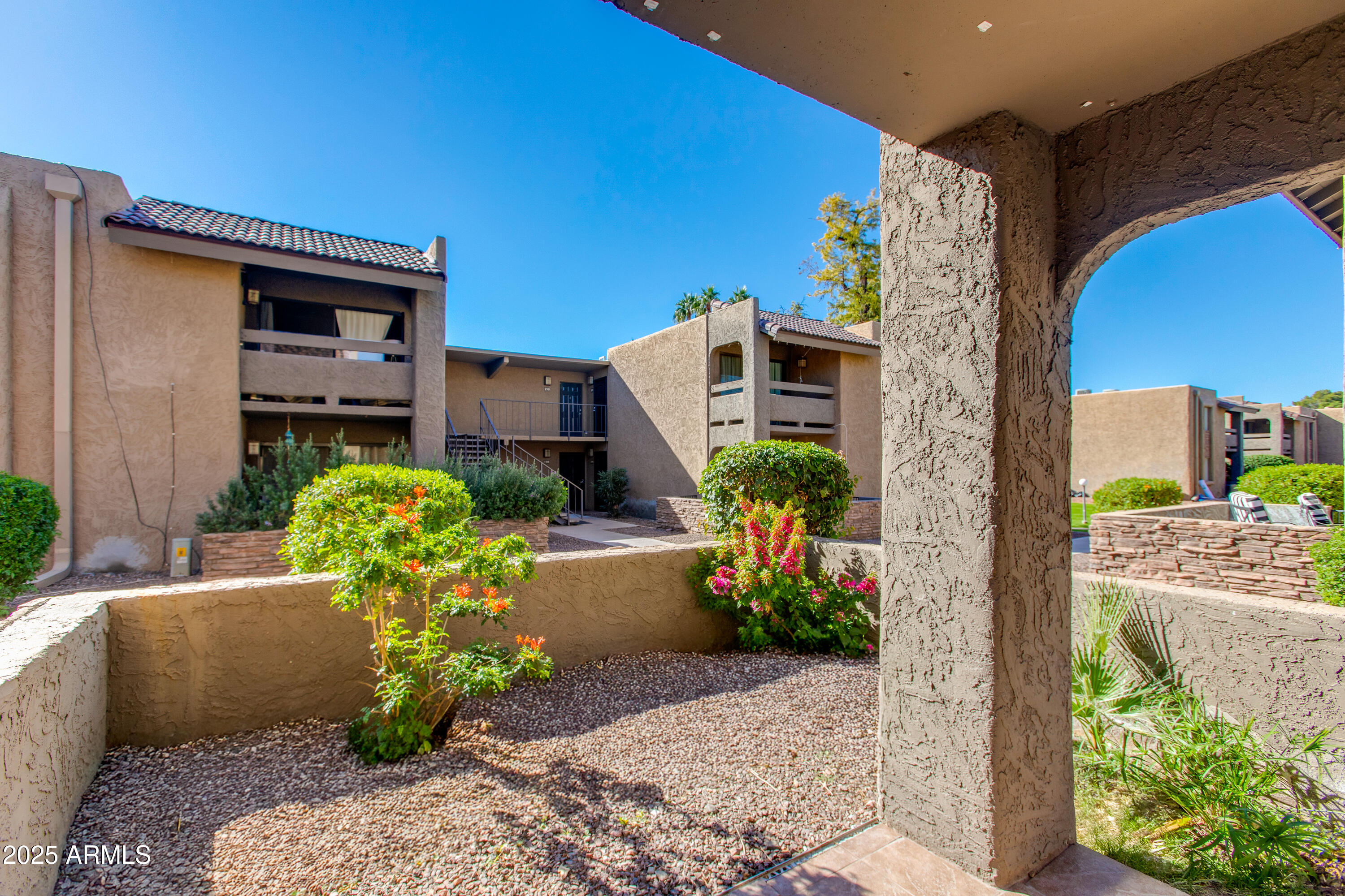 3825 East Camelback Road, Unit 105 Phoenix, AZ 85018 - Photo 10 of 14 a front view of a house with a yard