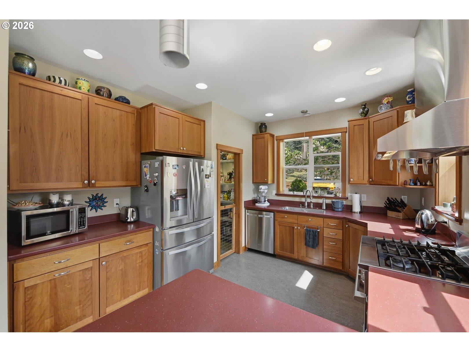 62736 Olive Barber Road Coos Bay, OR 97420 - Photo 11 of 25 a kitchen with stainless steel appliances kitchen island granite countertop a refrigerator stove top oven and sink