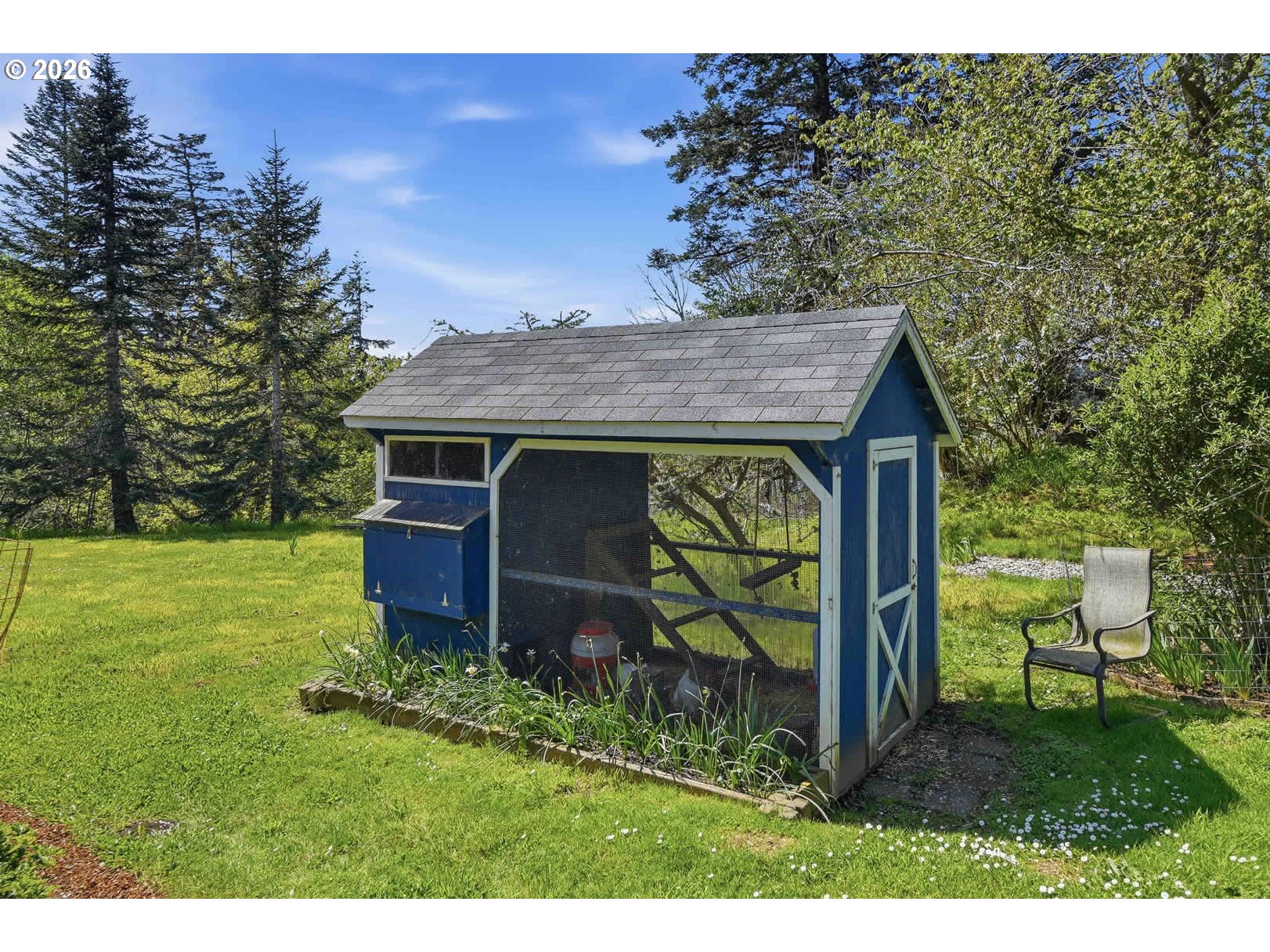 62736 Olive Barber Road Coos Bay, OR 97420 - Photo 6 of 25 a view of a backyard with potted plants and large tree