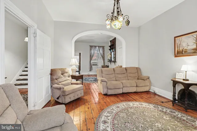 a living room with furniture and a chandelier