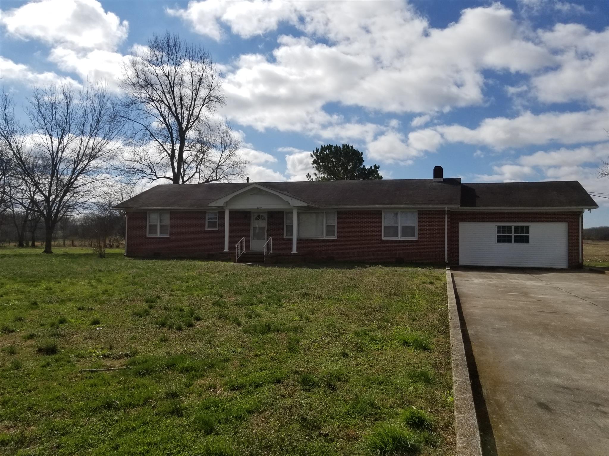 1309 Smith Road Manchester, TN 37355 - Photo 1 of 18 a view of a house with a yard