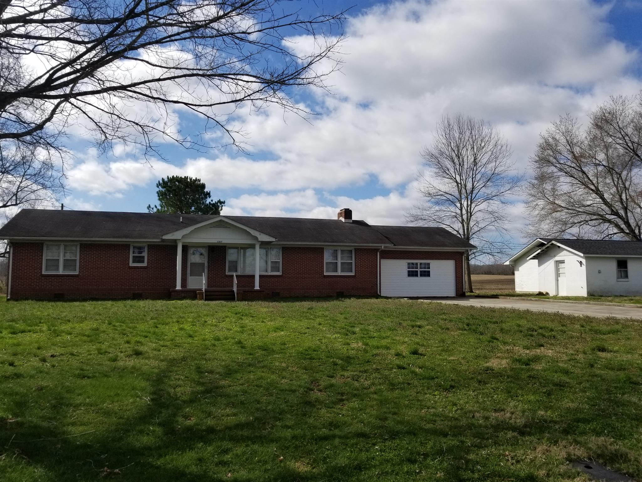 1309 Smith Road Manchester, TN 37355 - Photo 18 of 18 a large house with a big yard and large trees