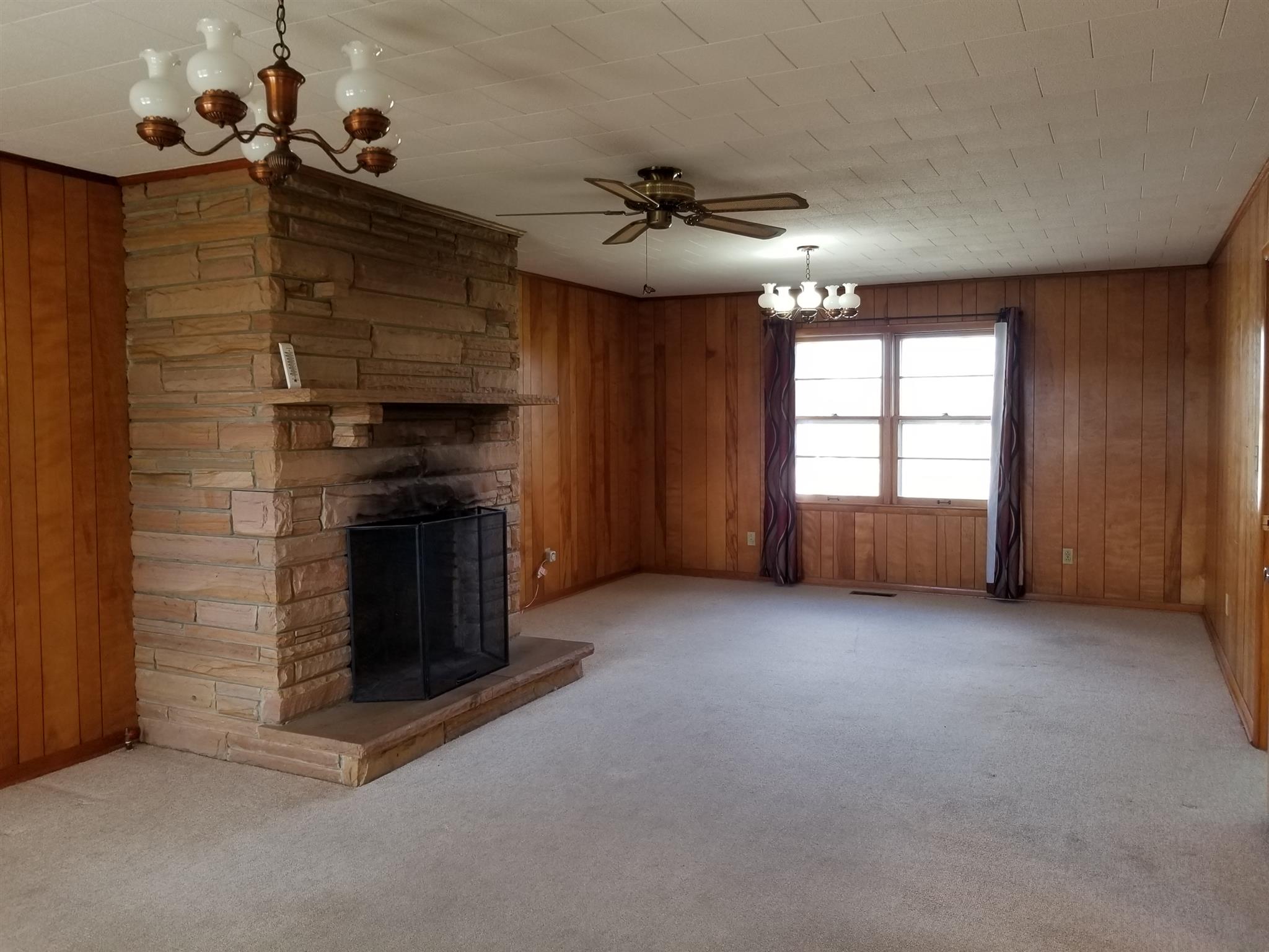 1309 Smith Road Manchester, TN 37355 - Photo 6 of 18 an empty room with windows and fireplace
