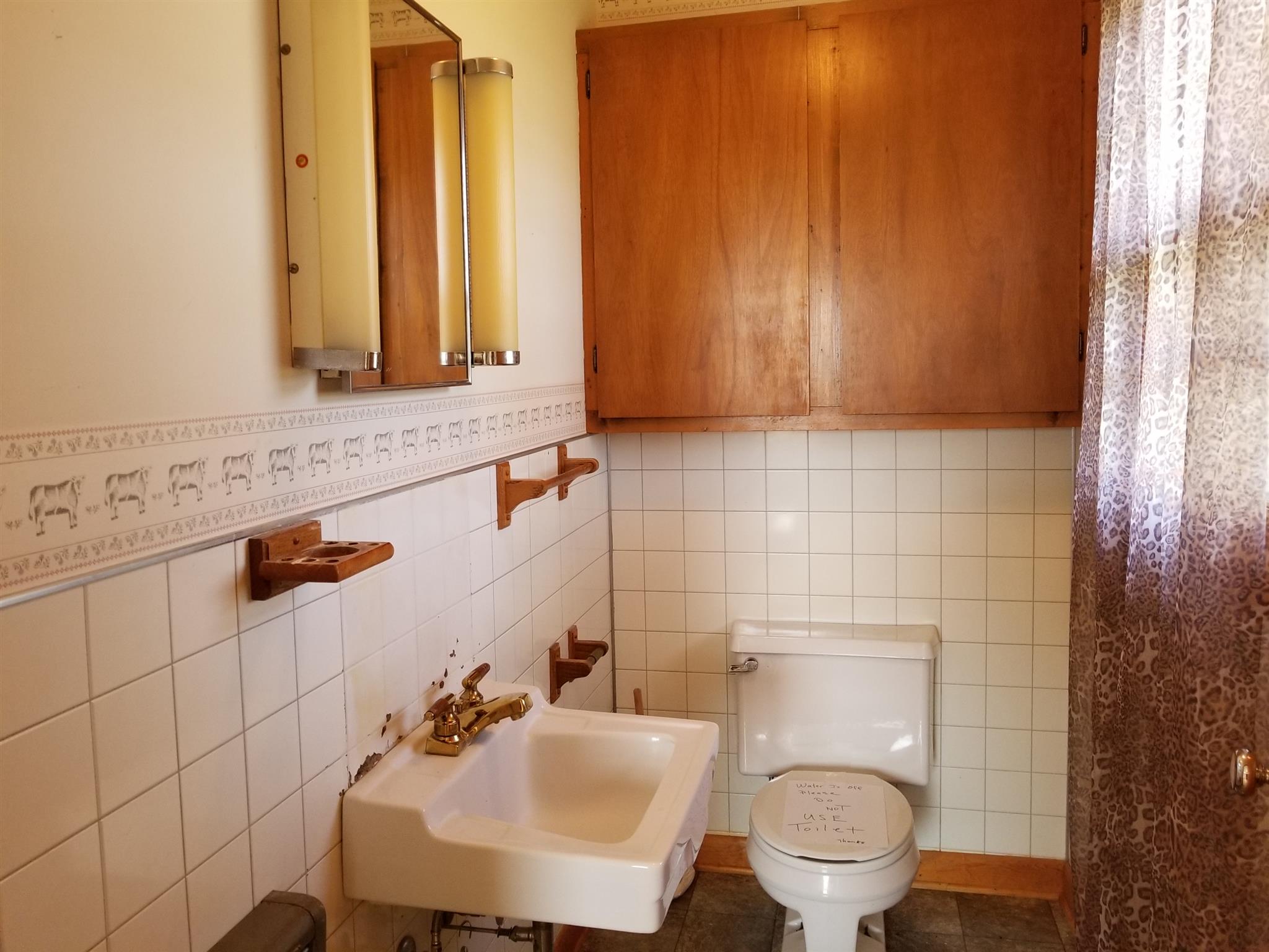 1309 Smith Road Manchester, TN 37355 - Photo 8 of 18 a bathroom with a sink a toilet and mirror