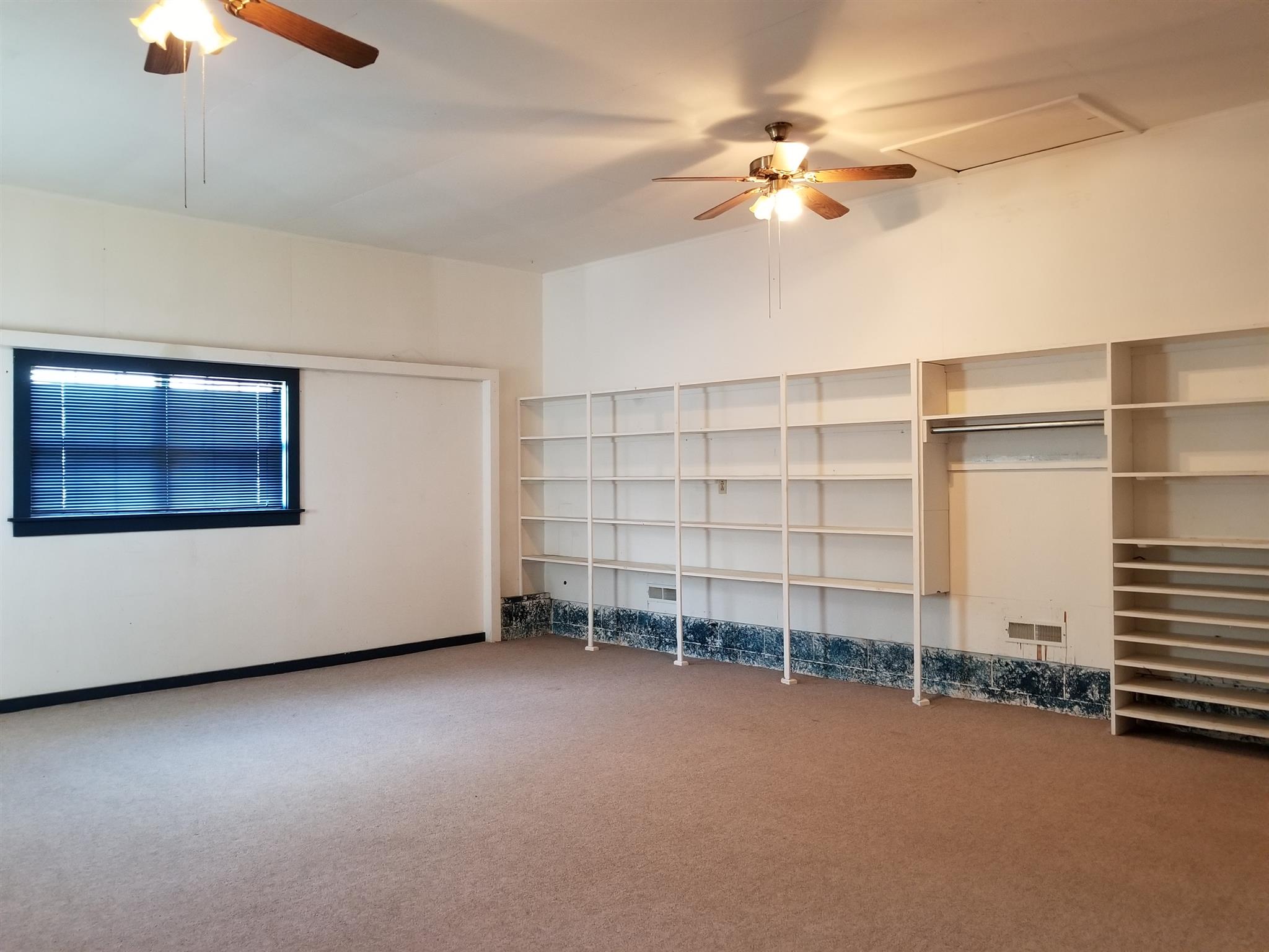 1309 Smith Road Manchester, TN 37355 - Photo 9 of 18 wooden floor in an empty room with a window