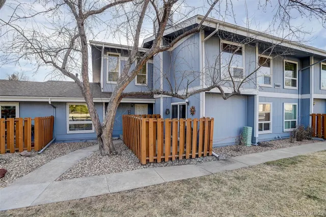 a view of a house with wooden fence