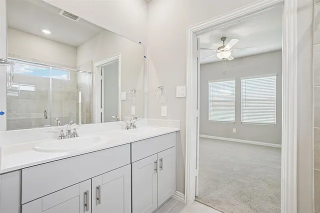 a bathroom with a sink double vanity and a mirror