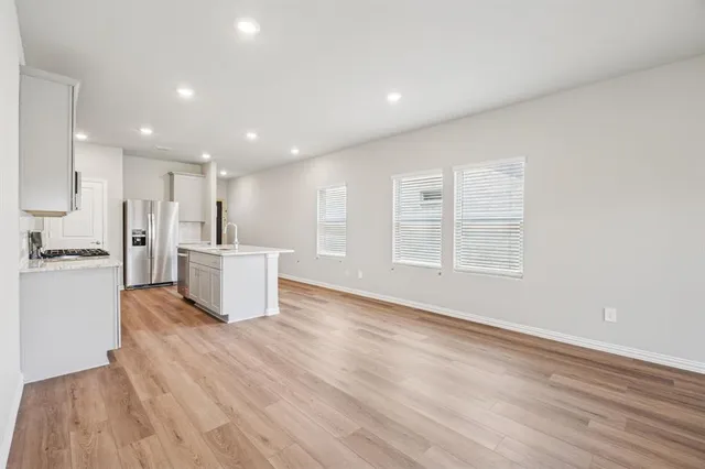 a view of kitchen with stainless steel appliances refrigerator microwave and stove