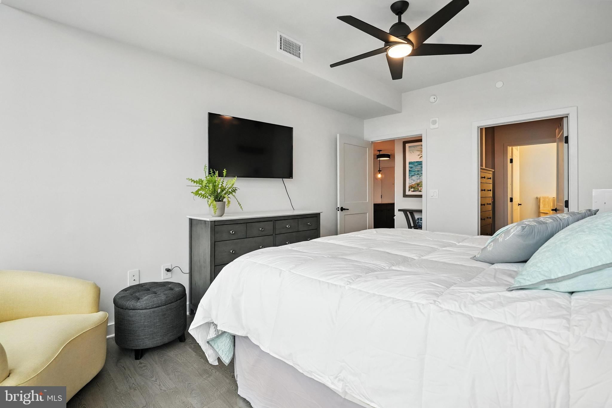 70 N Street Southeast, Unit N913 Washington, DC 20003 - Photo 12 of 77 a bedroom with a bed a couch and a flat screen tv