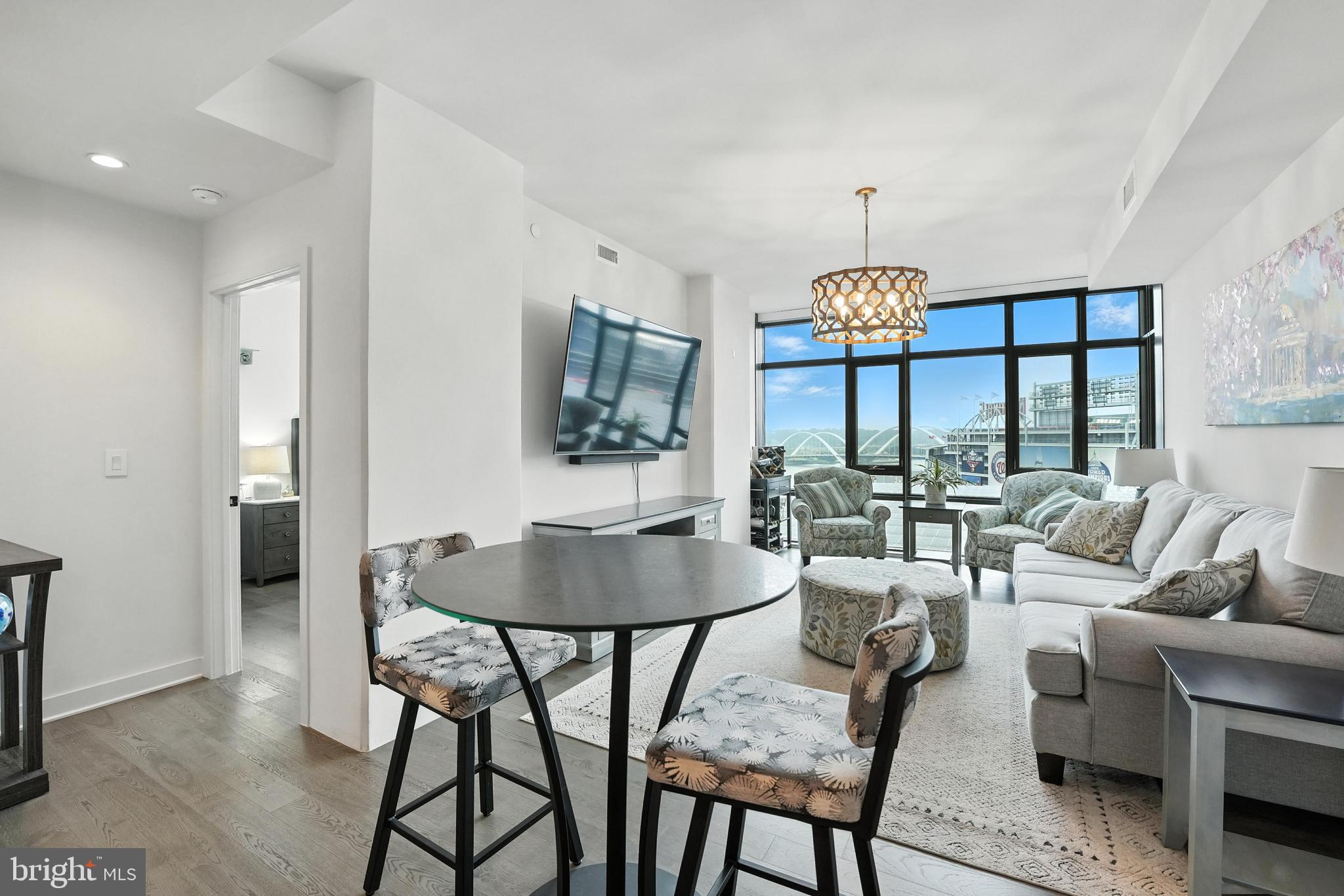 70 N Street Southeast, Unit N913 Washington, DC 20003 - Photo 2 of 77 a living room with furniture a chandelier and a table