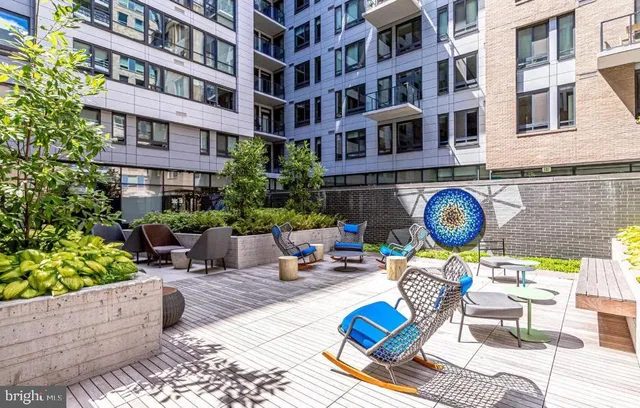 a view of a patio with dining table and chairs with a barbeque grill and a fireplace