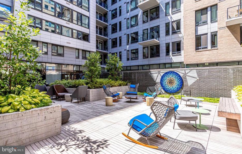 70 N Street Southeast, Unit N913 Washington, DC 20003 - Photo 42 of 77 a building outdoor space with patio furniture and potted plants