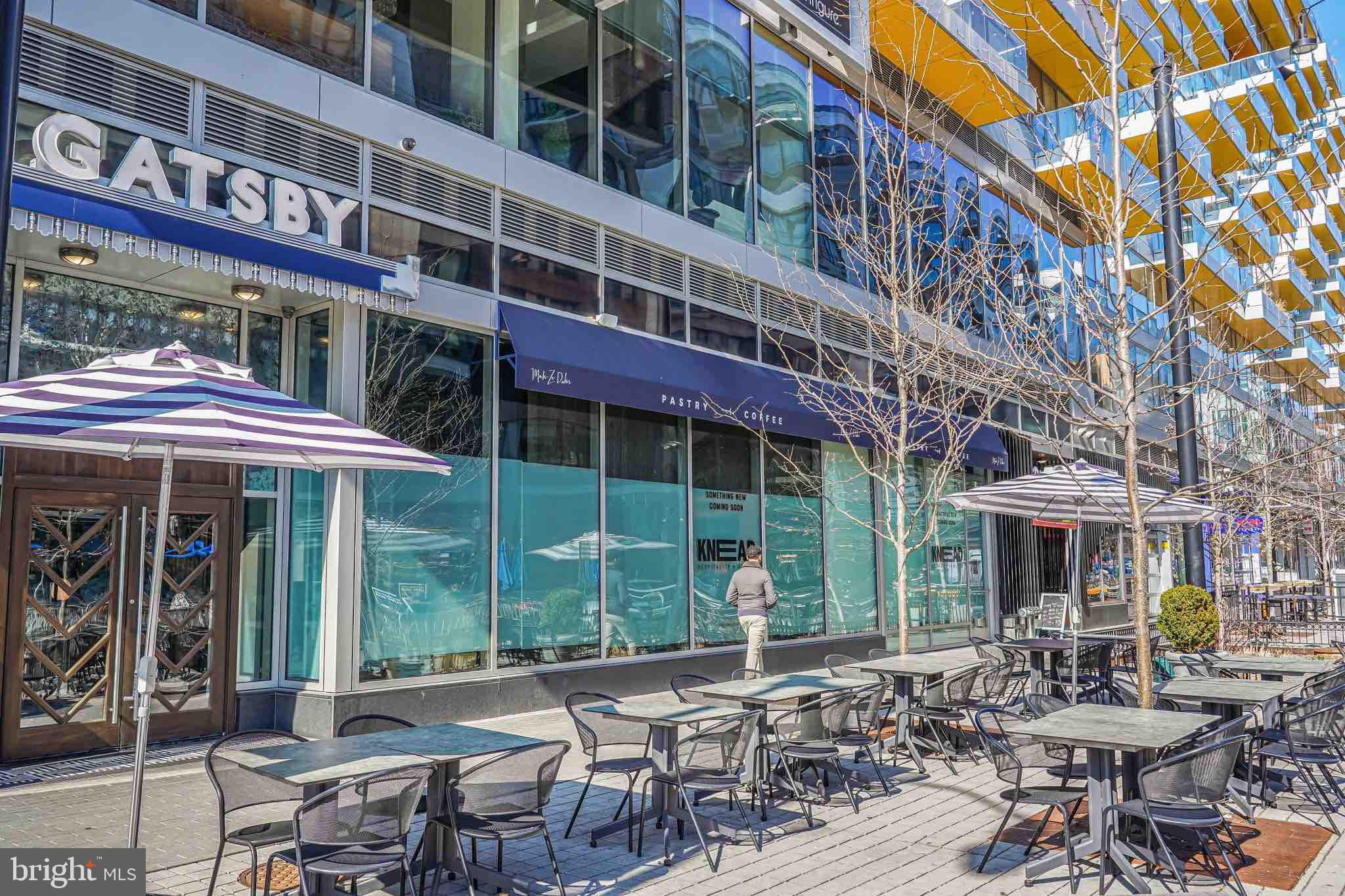 70 N Street Southeast, Unit N913 Washington, DC 20003 - Photo 67 of 77 a view of a building with a table and chairs under an umbrella